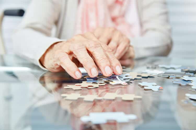 A senior working on a puzzle to help dementia prevention.