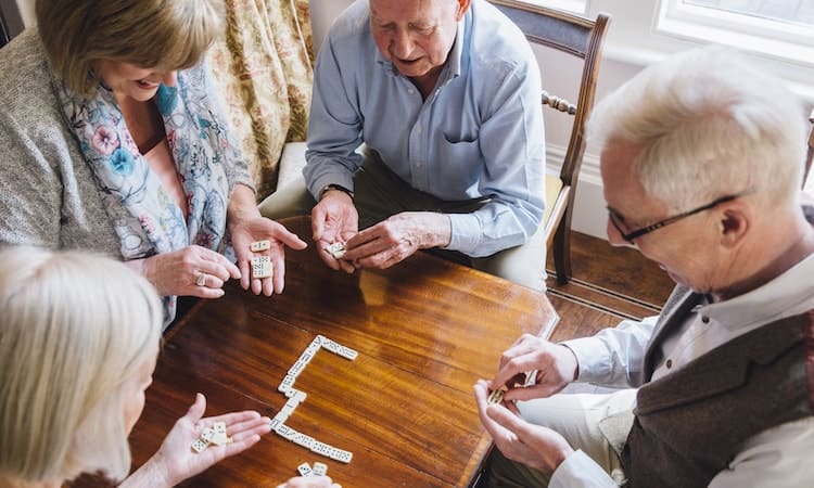 Seniors staying socially active with a fun game of dominoes