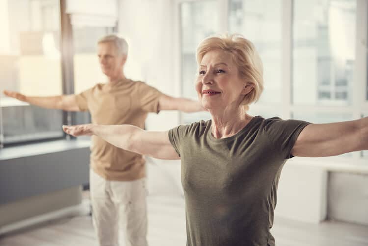 Older woman and man in workout class.