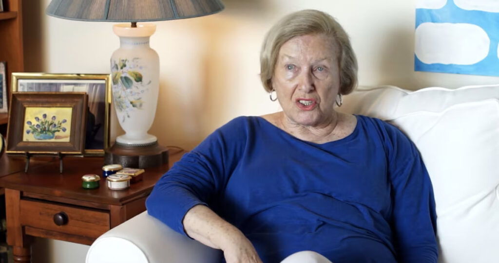 senior woman in blue shirt on couch