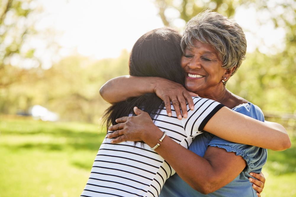 A child hugging her senior mother