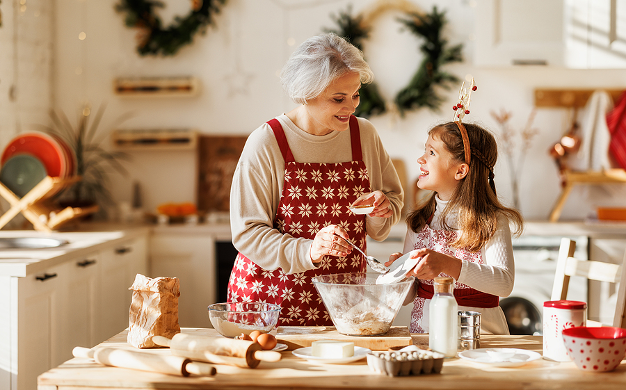 A grandma bakes holiday cookies with her granddaughter.