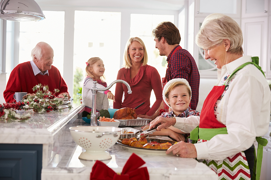 Senior woman baking with her loved ones during the holiday season.