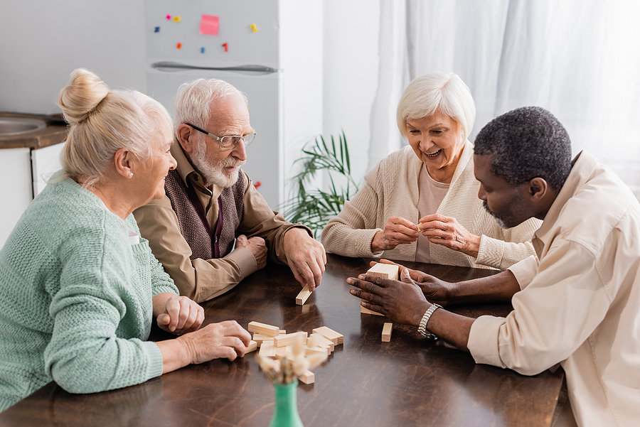Excited Senior Woman Smiling While Playing Tower Wood Blocks Gam