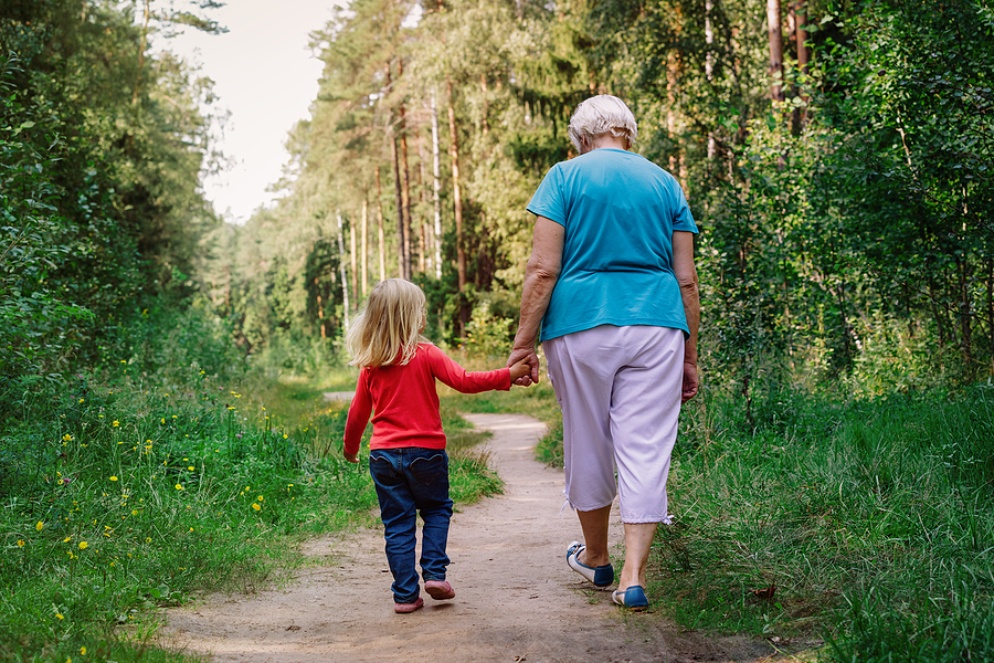 Granddaughter and grandmother walking outside together