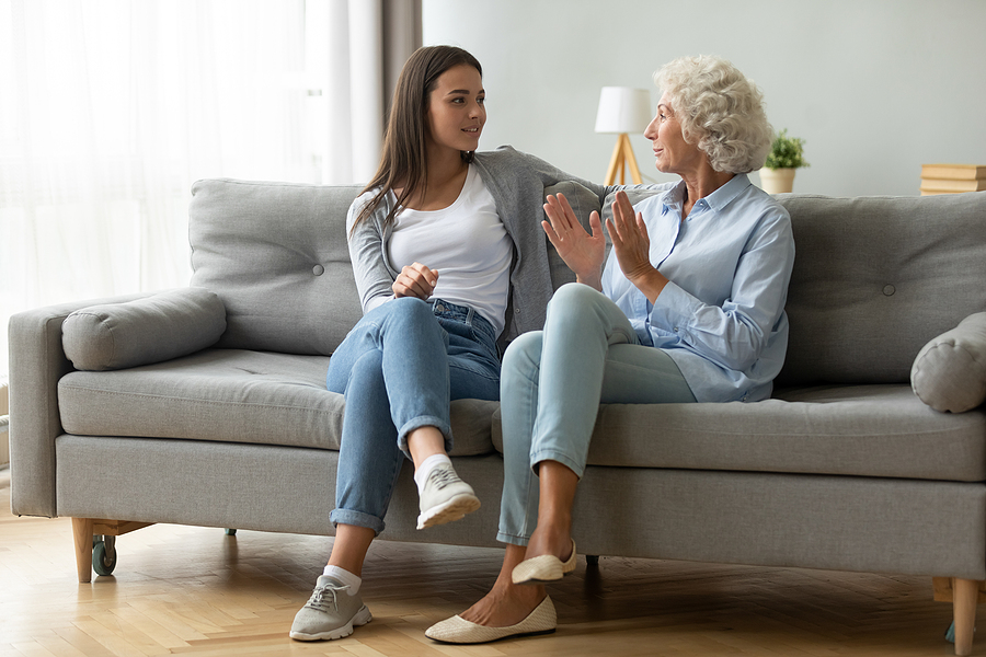 Woman talking with older adult mom during Women’s History Month