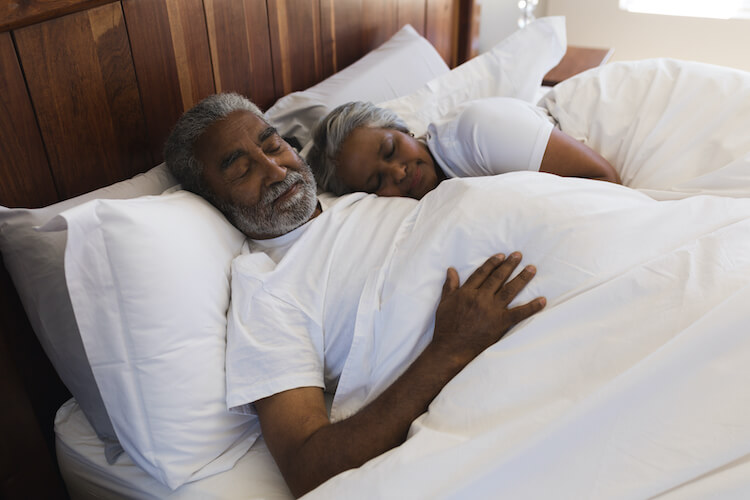 A senior man and woman get a good night’s sleep.