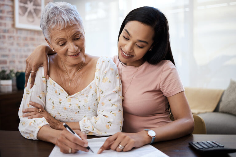 Senior woman and adult daughter going over finances